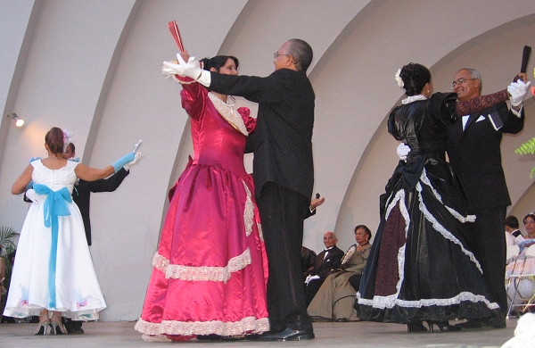 Concursantes adultos con abanicos y guantes
